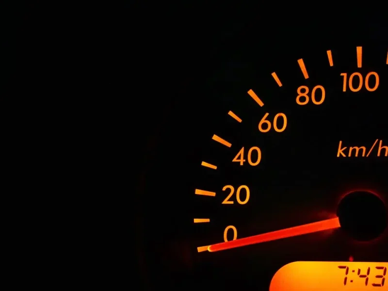 Rev counter lit up on a dark dashboard
